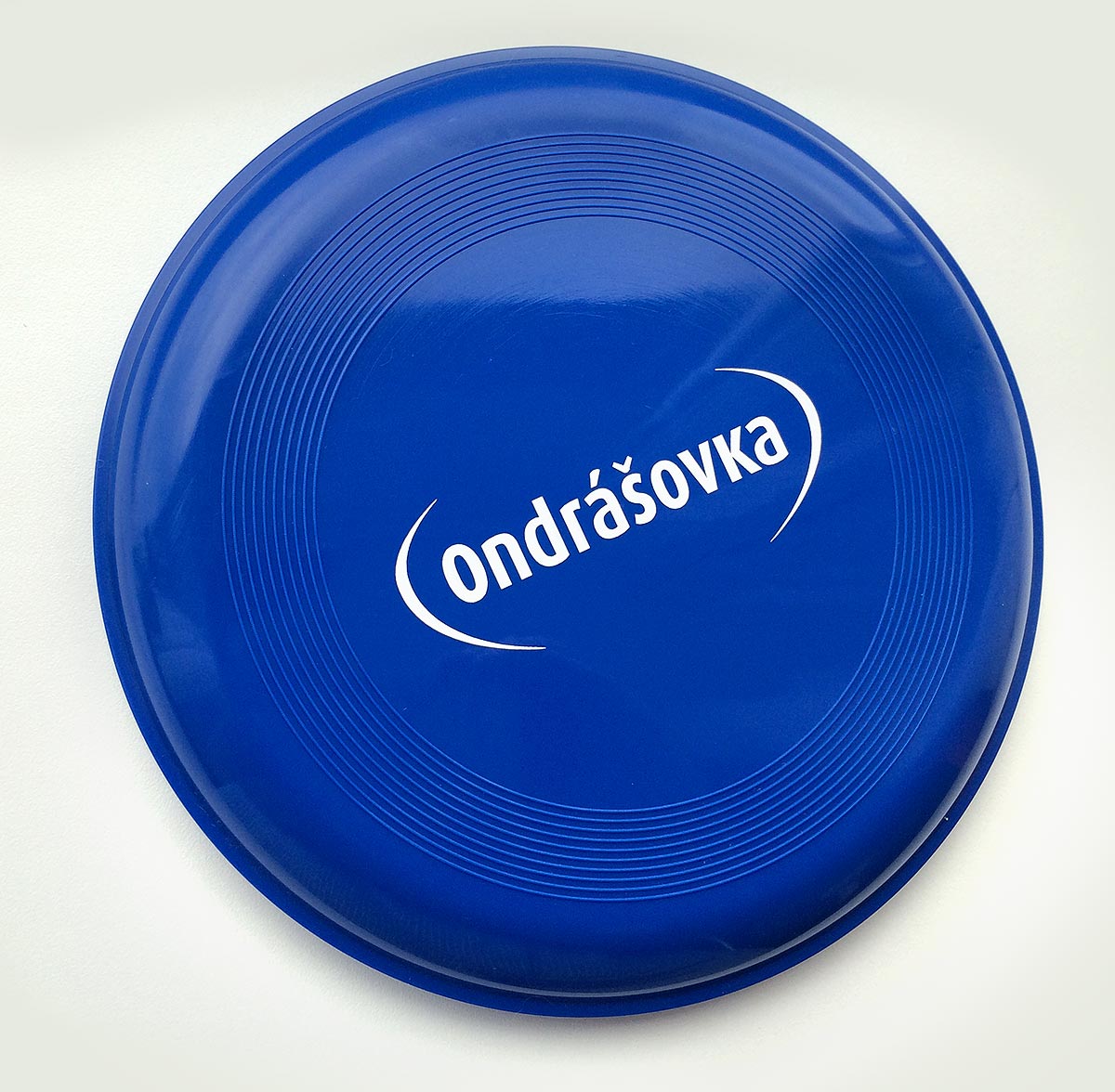 Reklamní modré létající frisbee s potiskem loga Ondrášovka